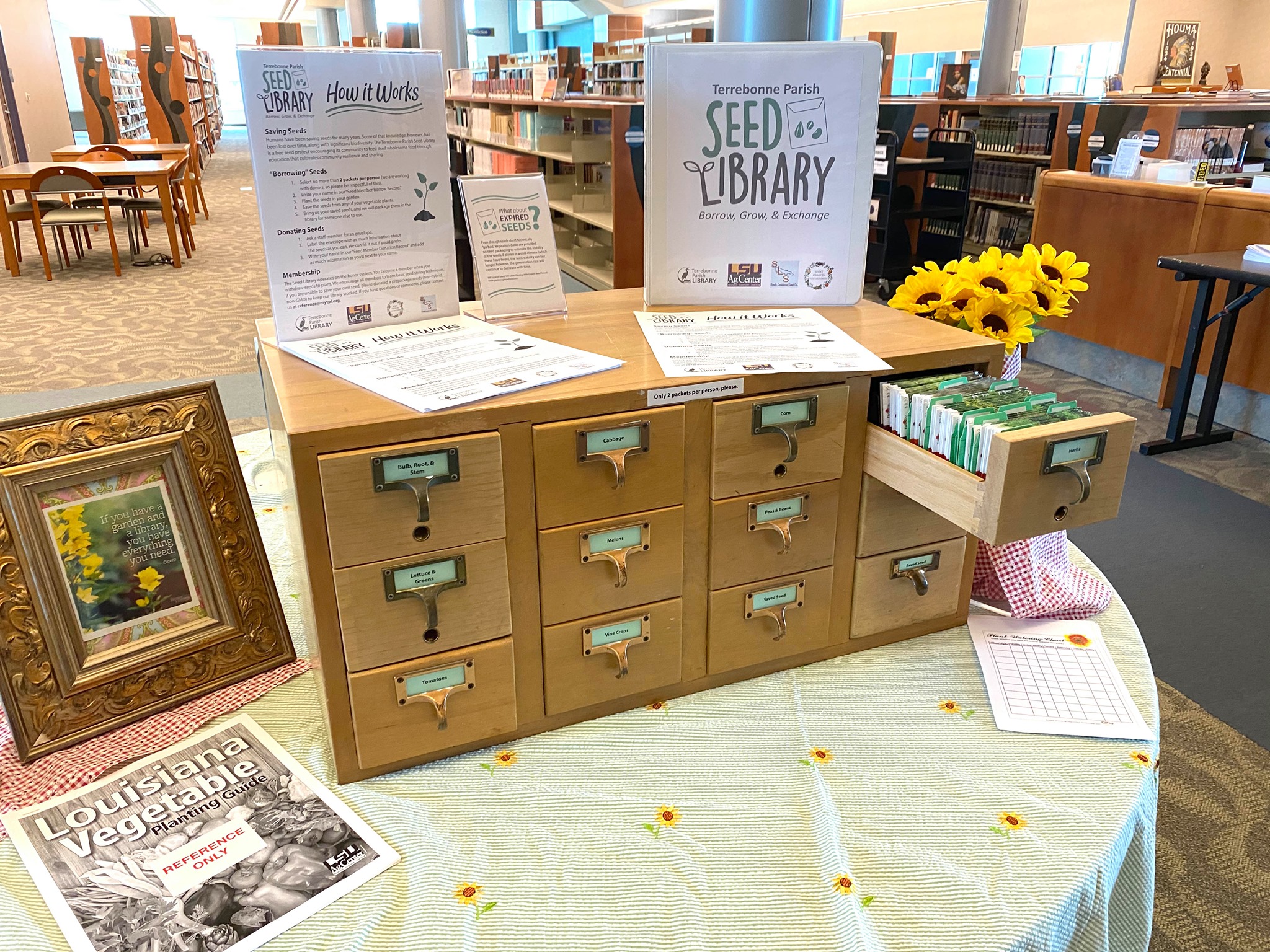 Seed library start sign display on a small cabinet.